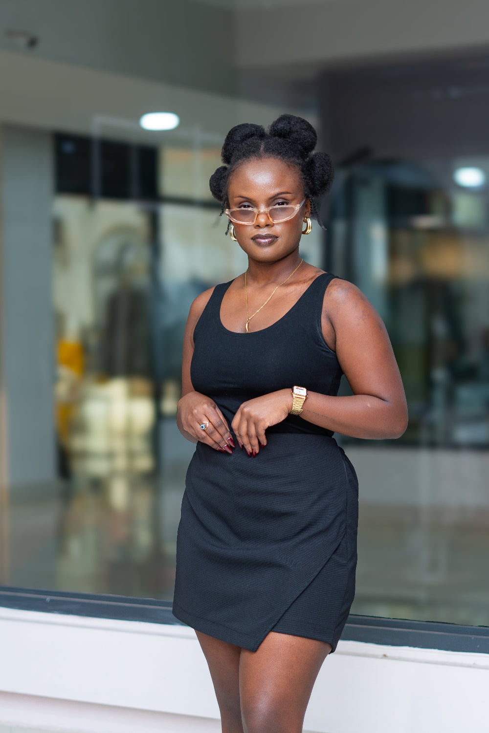 Woman in a black skort standing in front of a glass wall